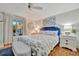 Bright bedroom featuring hardwood floors, coastal decor, and a comfortable king-size bed at 7817 Alhambra Dr, Bradenton, FL 34209