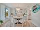 Charming dining room with chandelier, beachy decor, and stainless steel appliances at 7817 Alhambra Dr, Bradenton, FL 34209