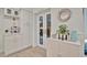 Inviting entryway with white cabinets, french doors, and stylish coastal decor at 7817 Alhambra Dr, Bradenton, FL 34209