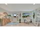 Bright entryway featuring hardwood floors, a decorative mirror, stylish console table, and an adjacent office space with a large window at 7817 Alhambra Dr, Bradenton, FL 34209