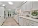 Bright kitchen with white cabinets, modern appliances, and a view of the backyard through glass doors at 7817 Alhambra Dr, Bradenton, FL 34209