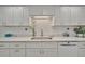 Close-up of the kitchen with modern appliances and white cabinetry, quartz countertops and ample space at 7817 Alhambra Dr, Bradenton, FL 34209