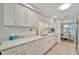 Bright and airy kitchen with white cabinetry, modern appliances, and a view of the dining area at 7817 Alhambra Dr, Bradenton, FL 34209