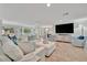 Bright, open-concept living room with comfortable seating and access to kitchen at 7817 Alhambra Dr, Bradenton, FL 34209