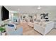 Airy living room with ample seating, stylish decor, and great flow to other rooms at 7817 Alhambra Dr, Bradenton, FL 34209