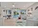 Bright living room with white wainscoting, comfortable seating, and view to the pool at 7817 Alhambra Dr, Bradenton, FL 34209