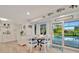 Open living area with breakfast nook, view to the pool, and coastal decor at 7817 Alhambra Dr, Bradenton, FL 34209