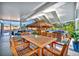 The covered patio features a dining area, bar, and cozy seating, ideal for entertaining or relaxing outdoors at 7817 Alhambra Dr, Bradenton, FL 34209