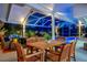 Outdoor dining area with seating for six under covered patio near an enclosed pool area at 7817 Alhambra Dr, Bradenton, FL 34209
