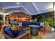 Outdoor patio area with tiki bar, fire pit, and ample seating for entertaining guests at 7817 Alhambra Dr, Bradenton, FL 34209