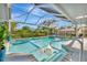 Screened pool with clear blue water, a lounge chair and tropical landscaping, offering a serene outdoor experience at 7817 Alhambra Dr, Bradenton, FL 34209