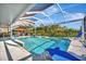 Screened-in pool area with a tiki bar and ample space for relaxation at 7817 Alhambra Dr, Bradenton, FL 34209