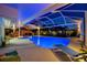 Inviting covered pool area with lounge chairs, lush landscaping and a tiki bar perfect for outdoor entertaining at 7817 Alhambra Dr, Bradenton, FL 34209