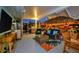 Outdoor entertainment space with grill, TV, tiki bar, and patio seating area at 7817 Alhambra Dr, Bradenton, FL 34209