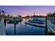 Scenic waterfront view of boats docked in a tranquil canal, highlighted by a beautiful sunset in the background at 7817 Alhambra Dr, Bradenton, FL 34209