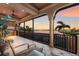 Covered balcony featuring an outdoor seating area with sunset views at 801 3Rd E St, Palmetto, FL 34221