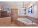 Bright bathroom featuring a soaking tub, walk-in shower, and decorative tile accents at 801 3Rd E St, Palmetto, FL 34221