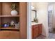 Well-lit bathroom with a wood vanity and an ornate mirror, plus decorative touches at 801 3Rd E St, Palmetto, FL 34221
