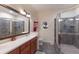 Well-lit bathroom featuring a glass shower and a round window at 801 3Rd E St, Palmetto, FL 34221