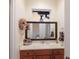 This bathroom features a framed mirror, blue accents, and a window for natural light at 801 3Rd E St, Palmetto, FL 34221