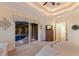 Bedroom with trey ceiling, ceiling fan, view of pool through glass doors, chest of drawers, and doorway at 801 3Rd E St, Palmetto, FL 34221