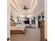 Well-lit main bedroom features a sitting area, tray ceiling with ceiling fan, and several windows with views at 801 3Rd E St, Palmetto, FL 34221