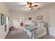 Neutral guest bedroom features two twin beds, a ceiling fan, and a view of the attached bathroom at 801 3Rd E St, Palmetto, FL 34221