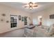 Bright guest bedroom features two beds, a ceiling fan, and natural light from two large windows at 801 3Rd E St, Palmetto, FL 34221