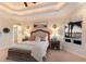 Bedroom with plush bedding, decorative lamps, and sunset view from the window at 801 3Rd E St, Palmetto, FL 34221