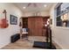 Bonus room with wall cabinet, wood-look tile floor, guitar on wall, and sunset view from window at 801 3Rd E St, Palmetto, FL 34221