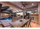 Stunning outdoor dining area with fireplace, summer kitchen, and a view of the pool and waterway at 801 3Rd E St, Palmetto, FL 34221