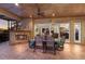 Elegant covered patio with outdoor dining, a fireplace, and seamless indoor-outdoor flow for entertaining at 801 3Rd E St, Palmetto, FL 34221