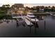View of a well-maintained boat docked at a private pier on the water with beautiful homes nearby at 801 3Rd E St, Palmetto, FL 34221