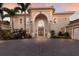 Elegant exterior highlighting a grand archway entrance and manicured landscaping at 801 3Rd E St, Palmetto, FL 34221