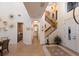 Grand foyer featuring tile flooring, a staircase with decorative mural, and access to a dining area and bar at 801 3Rd E St, Palmetto, FL 34221