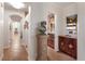Elegant hallway leading to various rooms, showcasing a statue and a bar area at 801 3Rd E St, Palmetto, FL 34221