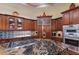 Close-up of kitchen island featuring granite countertop, custom cabinetry, and cooktop at 801 3Rd E St, Palmetto, FL 34221