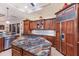 Gourmet kitchen features custom wood cabinets, exotic granite, and a professional gas cooktop on a large island at 801 3Rd E St, Palmetto, FL 34221