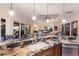 Open floor plan; kitchen features granite countertops, a bar, and flows into a living area with beautiful waterfront views at 801 3Rd E St, Palmetto, FL 34221