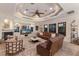 Comfortable living room features a fireplace, entertainment center, a ceiling fan, and an intricate ceiling design at 801 3Rd E St, Palmetto, FL 34221