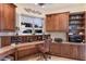 This home office features custom wood cabinetry, granite countertops, and great natural light with backyard views at 801 3Rd E St, Palmetto, FL 34221