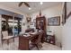 Home office featuring a wooden desk, built-in shelving, and a view of the outdoor pool area at 801 3Rd E St, Palmetto, FL 34221