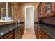 Elegant pantry featuring dark wood cabinets, granite countertops, and a beverage refrigerator at 801 3Rd E St, Palmetto, FL 34221