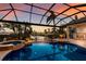Breathtaking pool area with a hot tub, waterfront views, and a screened enclosure for year-round enjoyment at 801 3Rd E St, Palmetto, FL 34221