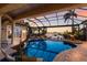 Screened pool area with a mermaid statue and a serene waterfront view at 801 3Rd E St, Palmetto, FL 34221