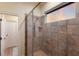 The walk-in shower has a glass enclosure and beautiful tiling at 801 3Rd E St, Palmetto, FL 34221