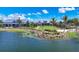 Beautiful aerial view of a community with a central lake, manicured lawns and luxurious gray homes at 8069 Tidal Pointe Way, Sarasota, FL 34240