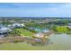 Aerial shot of a community with luxurious homes, a pool, lush landscaping and a lake at 8069 Tidal Pointe Way, Sarasota, FL 34240