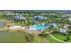 An expansive aerial view highlighting the pool, clubhouse, and surrounding natural beauty at 8069 Tidal Pointe Way, Sarasota, FL 34240