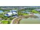 Overhead view of a community featuring a pool, clubhouse, green space, and waterfront at 8069 Tidal Pointe Way, Sarasota, FL 34240